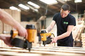 Nicklin worker building a wooden pallet